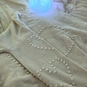 Heart knitted white sweater.